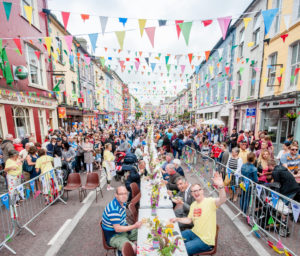 11-06-16. Happy diners enjoying lunch at the Clonakilty Street Carnival. In total, more than 1500 meals were served in 2 and a half hours. The carnival celebrates the reopening of the main street after 18 months of work to install a new flood relief system and a new streetscape, at a cost of €2.3 million. Photo by Dermot Sullivan.